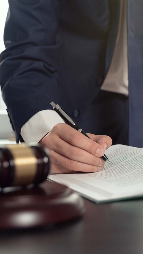 Criminal Defense attorney is signing papers